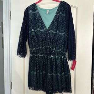 Women’s lace romper. Front closure and sheer sleeves